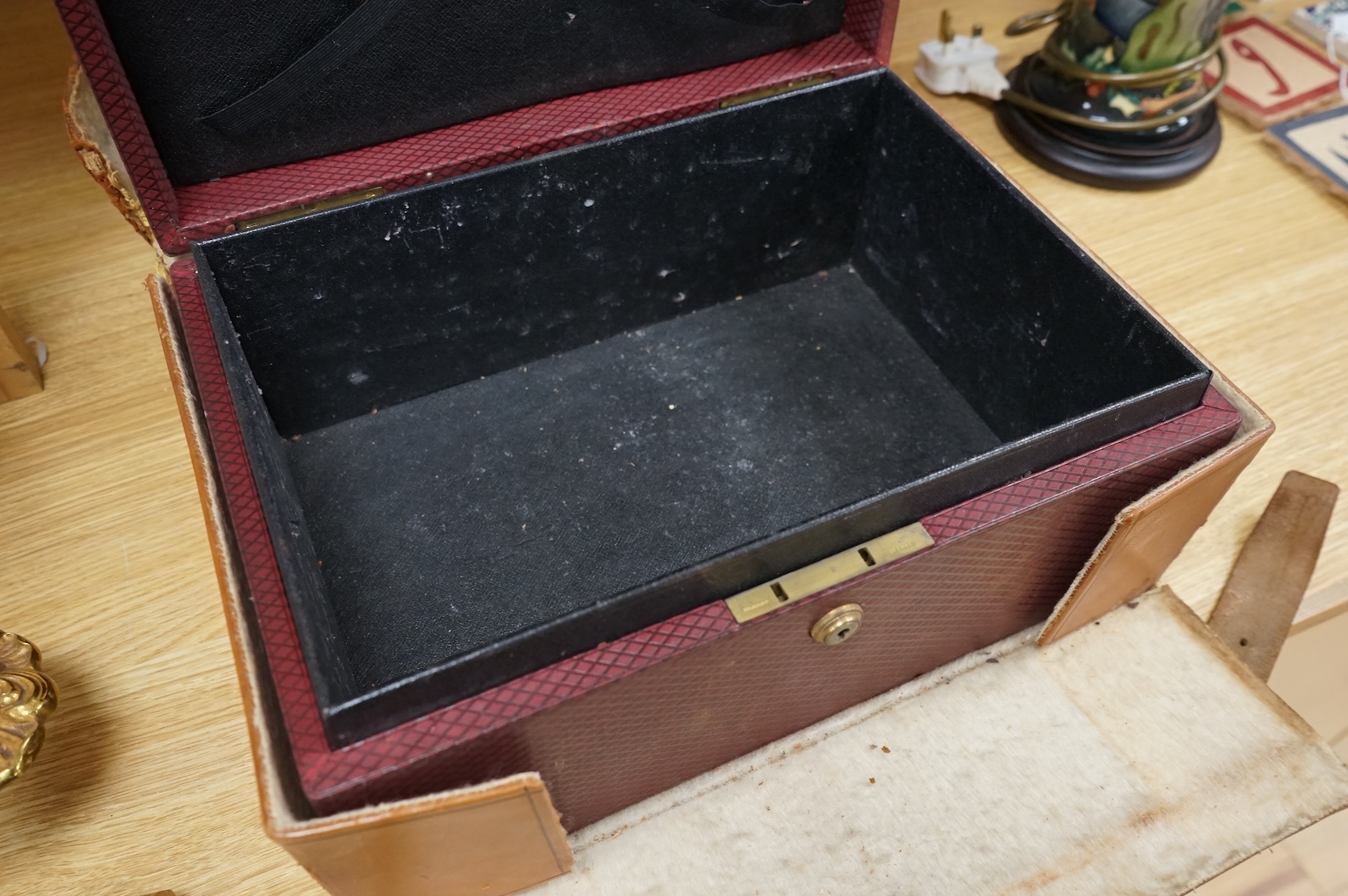 A cased travelling lock box with Bramah lock and leather case, no key, 36cm high